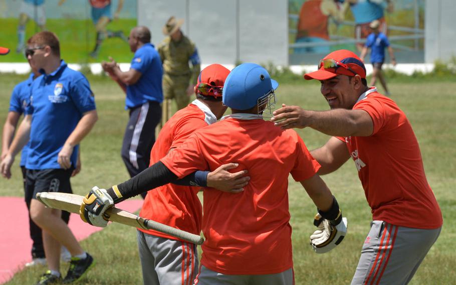 Afghan cricket players from a village outside Kabul celebrate their victoy over a NATO squad during an exhibition match at the Resolute Support base in Kabul, Afghanistan on May 8, 2016.