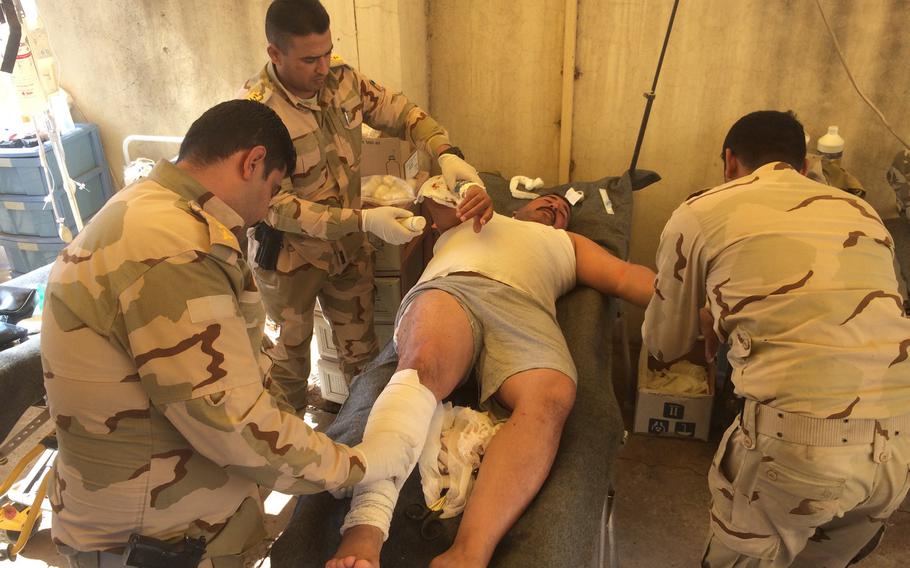 An Iraqi soldier injured in fighting in the al-Entsar district of Mosul to push the Islamic State out of the city is treated at a field hospital in an abandoned house near the city on Thursday, Nov. 3, 2016.