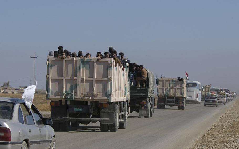 Vehicles carrying displaced people, many carrying white flags, clog a major road traveling away from the Iraqi city of Mosul on Thursday, Nov. 3, 2016. Iraqi forces have entered the outskirts of the city as they seek to oust the Islamic State from its last stronghold in the country.