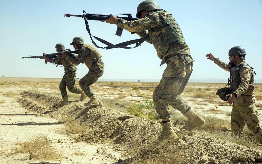 Afghan soldiers move as a squad during training at Camp Shorabak in June, 2018.  The Special Inspector General for Afghanistan Reconstruction, says the country's  forces are preventing the Taliban from capturing more territory, but are finding it difficult to extend their own area of control.