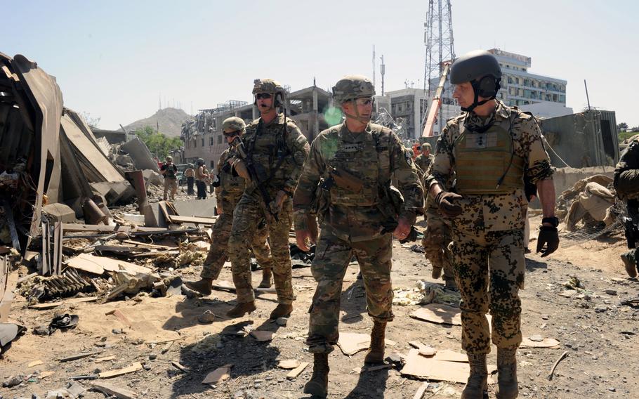Gen. John Nicholson, NATO Resolute Support commander, and his chief of staff, German Lt. Gen. Jurgen Weigt, visit the blast site after a deadly attack May 31, 2017, in Kabul, Afghanistan. Police say they have arrested the Taliban operative who planned the 2017 attack that killed 150 and injured more.