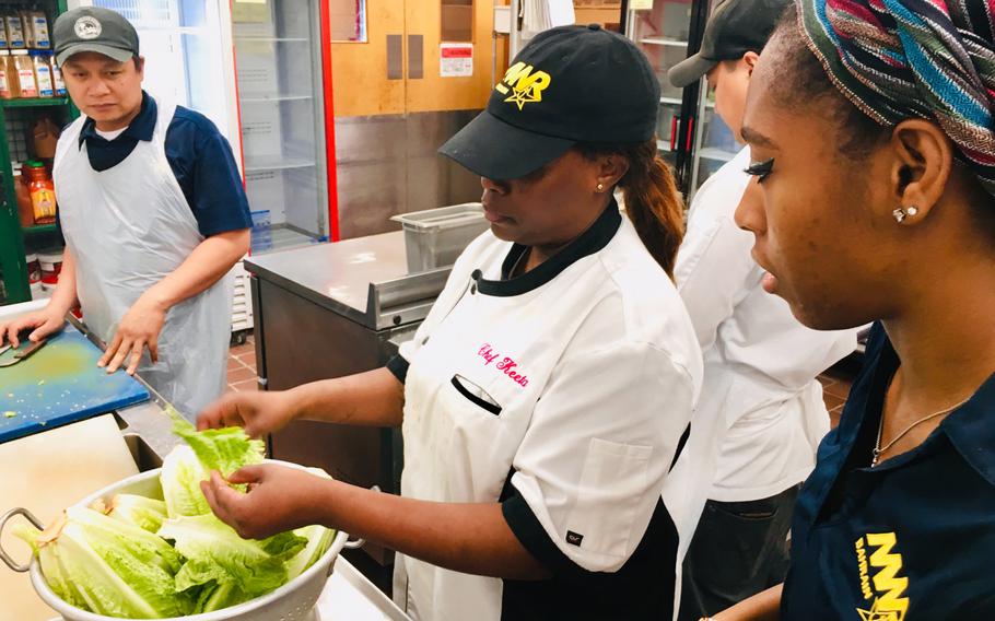 Chief Petty Officer and chef Markeeta Hardin directs cooking staff during a cooking class at Naval Support Activity Bahrain on April 15, 2019. Hardin, also known as Chef Keeta, has been cooking for most of her life. The 19-year security forces chief spends her off-time volunteering and serving up soul food to both servicemembers and locals through her Friday brunches, cooking classes and private events.