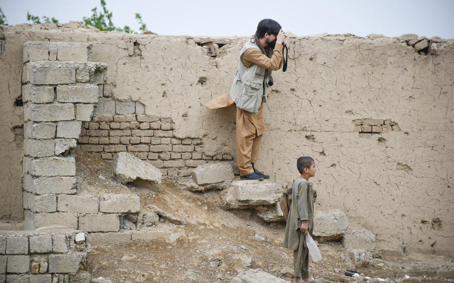 Chris Jones photographs Taliban ruins on the outskirts of Lashkar Gah, provincial capital of Helmand, April 14, 2019. The buildings had been destroyed in an American airstrike, locals said.