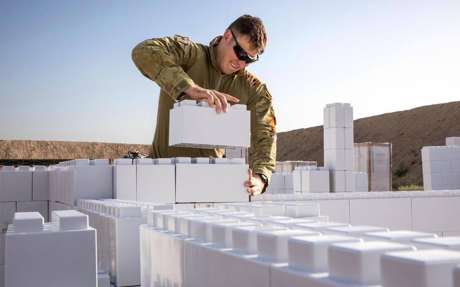 An Australian soldier works on installing a new modular urban training facility on Camp Taji, Iraq, June 2, 2019. The facility, made of hardened plastic bricks, are expected to last longer and allow for greater variety of training options than the wooden facades they are replacing.