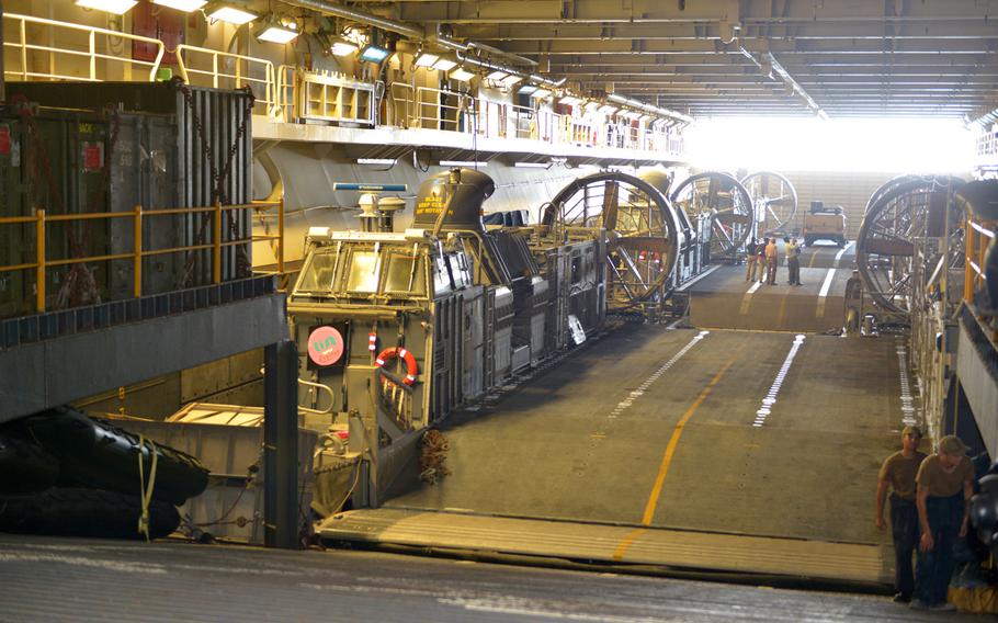 Three Landing Craft Air Cushion vehicles are parked in the well deck on board the amphibious assault ship USS Boxer on Aug. 1, 2019. Boxer pulled into Bahrain on July 25 for a scheduled weeklong port visit just days after crew members downed at least one drone during inbound transit through the Strait of Hormuz.