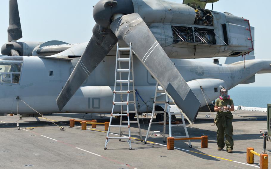 A Marine conducts maintenance on a MV-22 Osprey tilt-rotor aircraft on board the amphibious assault ship USS Boxer on Aug. 1, 2019. The Boxer pulled into Bahrain on July 25 for a scheduled weeklong port visit just days after crew members downed at least one drone during inbound transit through the Strait of Hormuz.