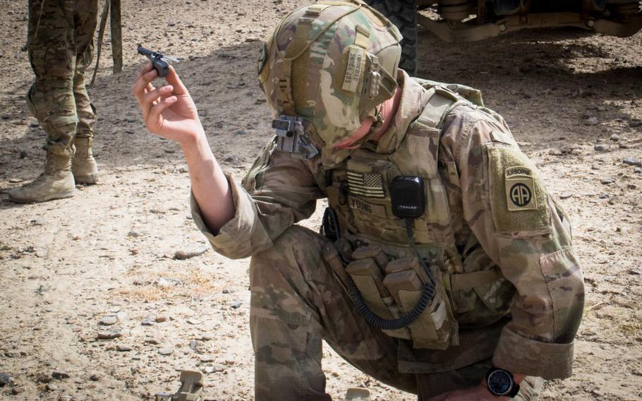 A paratrooper from the 3rd Brigade Combat Team, 82nd Airborne Division, prepares to launch a Black Hornet personal drone Friday, Aug. 9, 2019, in Kandahar, Afghanistan in support of a foot patrol. The 3rd Brigade is the first Army brigade to use the personal drones.