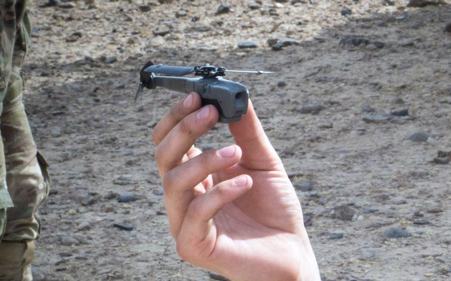 A paratrooper from the 3rd Brigade Combat Team, 82nd Airborne Division, prepares to launch a Black Hornet personal drone Friday, August 9, 2019, in Kandahar, Afghanistan, in support of a foot  patrol.