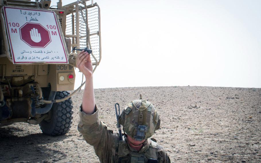 A paratrooper from the 3rd Brigade Combat Team, 82nd Airborne Division, prepares to launch a Black Hornet personal drone Friday, August 9, 2019, in Kandahar, Afghanistan, in support of a foot patrol.
