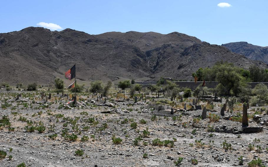 Afghanistan flags stand in a cemetery in Kunar province on Aug. 17, 2019, where an unknown Afghan soldier is said to be buried.