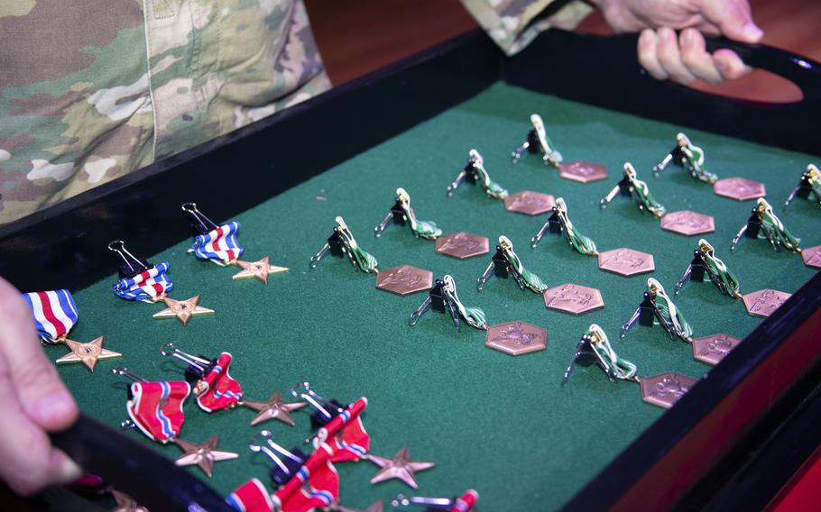 Valor awards lie in rows ready to be presented to the Green Berets of 2nd and 3rd Battalions, 10th Special Forces Group,  at a ceremony on Fort Carson, Colo., Sept. 26, 2019. The awards were presented for valorous actions during the battalions' most recent deployment to Afghanistan.