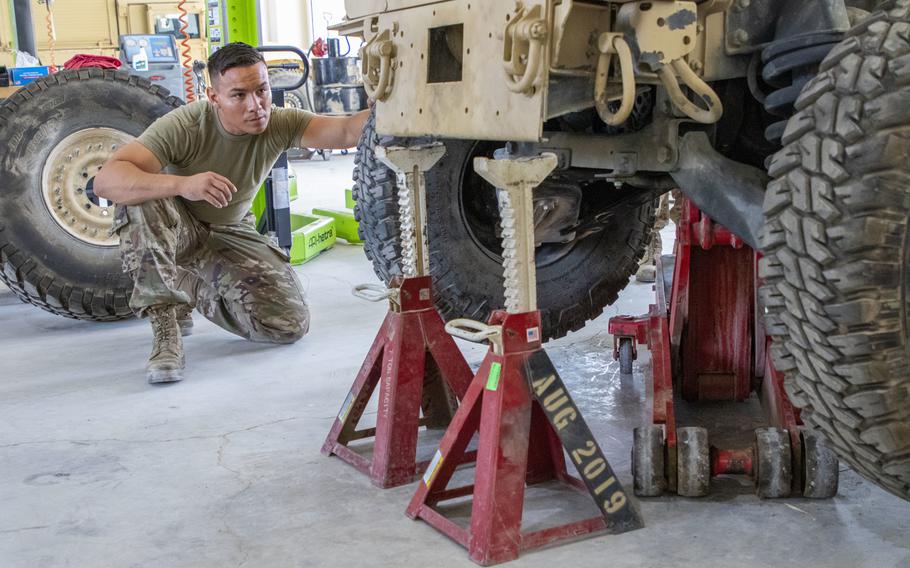 U.S. Army Spc. Sean-Paul Alcazar, Delta Company, 250th Brigade Support Battalion, watches as a tactical vehicle is lowered onto jack stands for maintenance in September at Joint Training Center-Jordan.