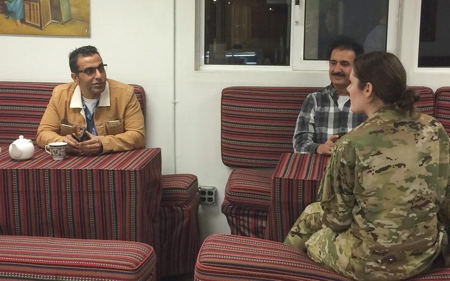 Jawid Kaderi, an Afghan-American contractor who works at Bagram Airbase, drinks tea with a fellow contractor and an airman, Sept. 19, 2019, at BAF Cafe. The cafe,the base?s newest eatery, aims to offer troops and others an authentic Afghan tea shop experience.