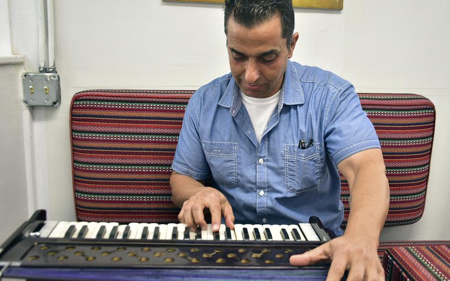 Jawid Kaderi, an Afghan-American contractor who works at Bagram Airfield, plays a traditional Afghan instrument, the harmonium, Sept. 19, 2019. Kaderi each week plays Afghan music to share his culture and history with troops on base.
