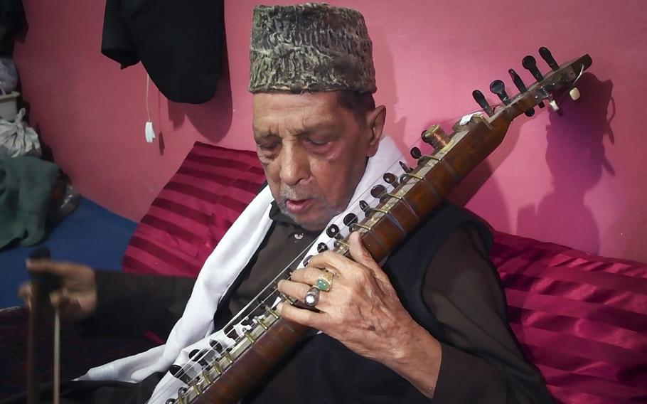 Ustad Amruddin plays a traditional Afghan instrument, the dilruba, at his home in the musician's quarter of Kabul, Afghanistan. Amruddin, 88, lived through the flourishing of music and the arts in Afghanistan in the 1950s, the banning of music under the Taliban and the return of musicians to the country after 2001.