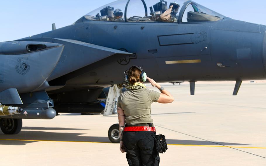 U.S. Air Force Senior Airman Emily Kline, a crew chief with the 378th Expeditionary Maintenance Squadron, salutes an F-15E Strike Eagle pilot prior to a sortie at Prince Sultan Air Base, Kingdom of Saudi Arabia, Jan. 8, 2020.