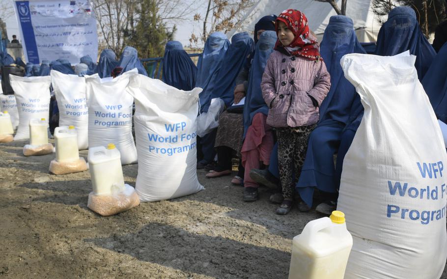 Lena, 7, waits with her mother to receive food from the United Nations World Food Program in Kabul, Afghanistan, Jan. 30, 2020. A third of the country's population may go hungry this winter, the U.S. Special Inspector General for Afghanistan Reconstruction reported.