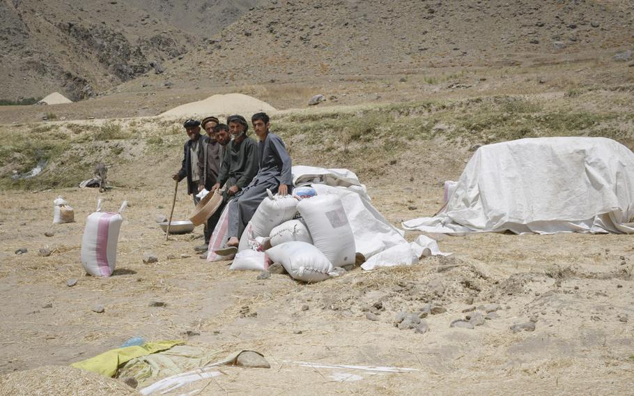 Farmers in rural Badakhshan province in Afghanistan take a break from their work July 14, 2019. The province has been the beneficiary of agricultural development projects by the United States Agency for International Development.