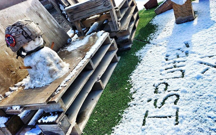 A small snowman sporting a military helmet was built at Camp Taji, Iraq, by Spanish soldier Cpl. David Miranda after a rare snowfall in Baghdad on Tuesday, Feb. 11, 2020.