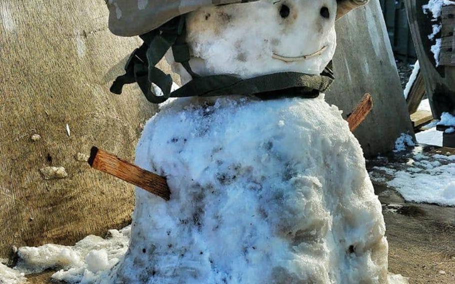 A small snowman sporting a military helmet was built at Camp Taji, Iraq, by Spanish soldier Cpl. David Miranda after a rare snowfall in Baghdad on Tuesday, Feb. 11, 2020.