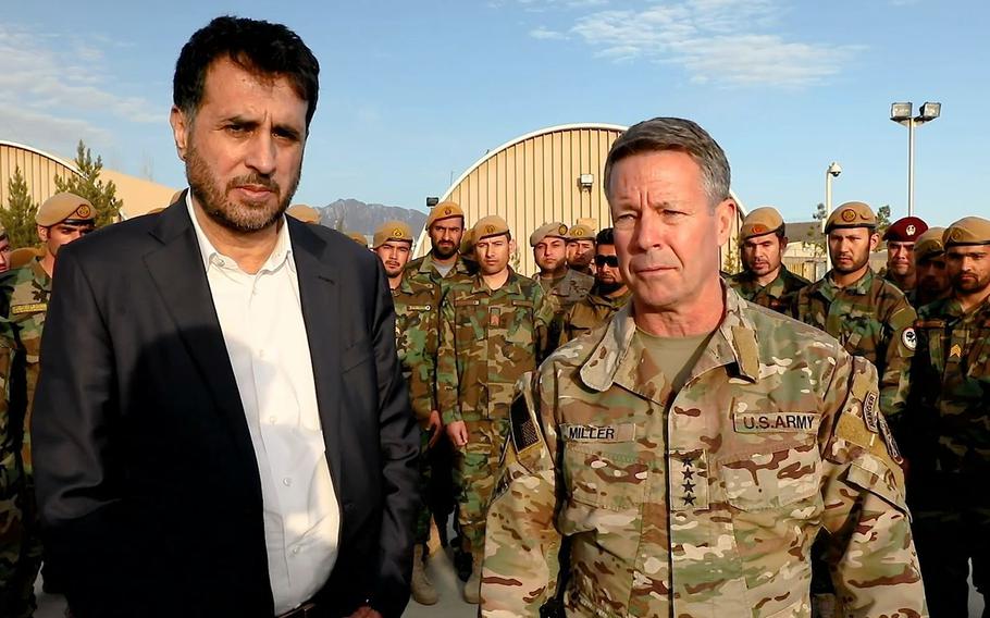Gen. Scott Miller, the top American commander in Afghanistan, right, and Afghan Defense Minister Asadullah Khalid visit a military base in southern Kandahar province on Tuesday, Feb. 26, 2020, where they said a weeklong period of reduced violence across the country had been successful so far.