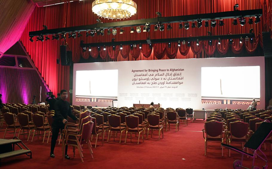 Workers at a luxury hotel in Doha, Qatar, set the stage on Friday, Feb. 28, 2020 for the expected signing of a peace agreement Saturday between the U.S. and the Taliban.