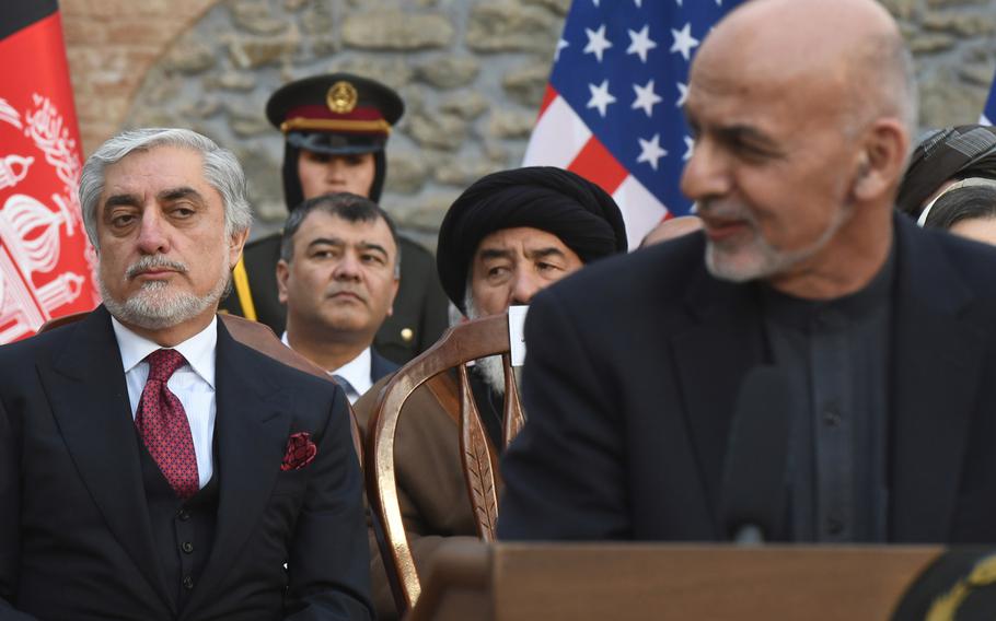 Afghan Chief Executive Abdullah Abdullah, left, watches President Ashraf Ghani deliver a speech in Kabul on Feb. 29, 2020. 