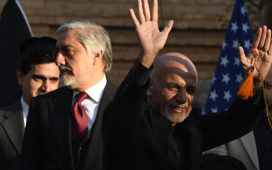 Afghan President Ashraf Ghani, right, and Abdullah Abdullah, his main political rival, attend a ceremony in Kabul on Feb. 29, 2020, after the U.S. and Taliban signed a peace deal. Each man has claimed victory in the country's 2019 presidential election and each held a swearing-in ceremony on Monday, March 9, 2020.