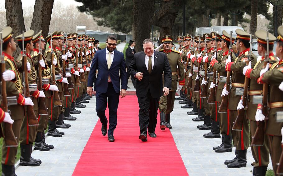 Secretary of State Mike Pompeo, right, and Afghan National Security Adviser Hamdullah Mohib arrive at the presidential palace in Kabul on Monday, March 23, 2020, when Pompeo paid a lightning visit to Afghanistan to try to resolve a political row that the U.S. says is stalling the peace process.