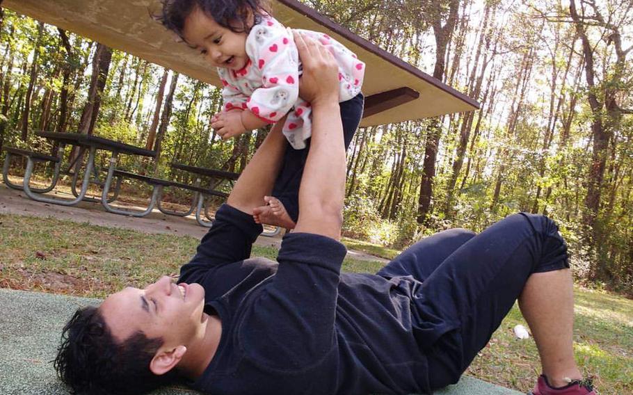Javier Jaguar Gutierrez plays with his daughter Helen during an outing in Crestview, Fla., in 2017.