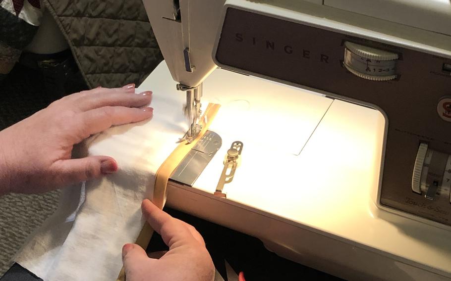 A volunteer for Soldiers' Angels, a charity based out of San Antonio, Texas, uses a sewing machine to make a face mask for a deployed service member, April 8, 2020.