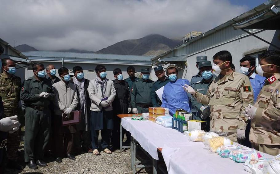 Afghan police receive medical supplies provided by U.S. and NATO forces in Afghanistan to help with efforts to combat the coronavirus pandemic in Panjshir and Parwan provinces, April 9, 2020.