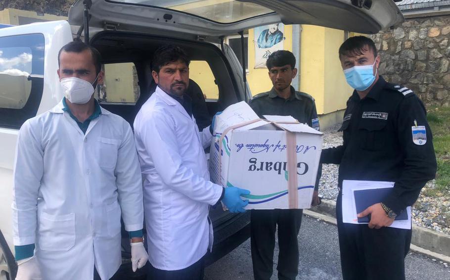 Afghan police receive medical supplies provided by U.S. and NATO forces in Afghanistan to help with efforts to combat the coronavirus pandemic in Panjshir and Parwan provinces, April 9, 2020.