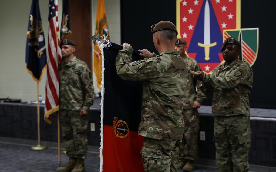 Col. James Dooghan, commander of the 4th Security Force Assistance Brigade, unveils the colors at their activation ceremony, Apr. 28, 2020, at Fort Carson, Colo. The brigade is due to deploy to Afghanistan in the fall.