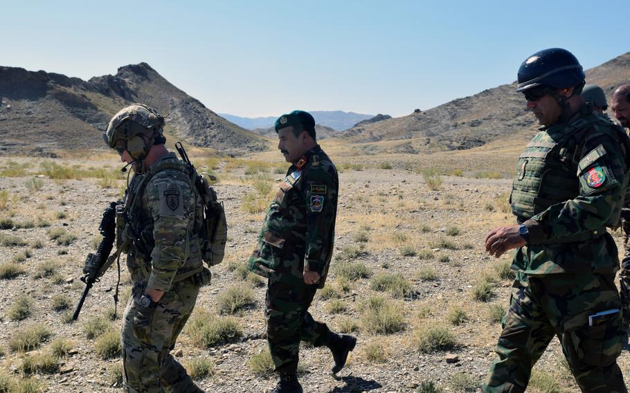 Advisers from the 2nd Security Force Assistance Brigade talk with Afghan forces during their June 2019 deployment to Afghanistan. Most advising has been done remotely since mid-March, an inspector general report said Tuesday.