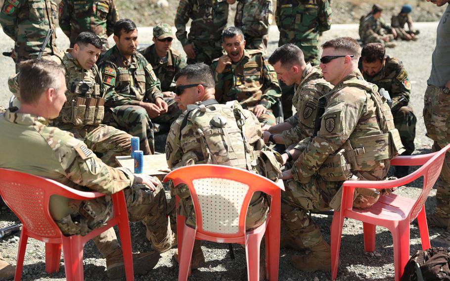 Advisers from the 2nd Security Force Assistance Brigade talk with Afghan forces in March 2019. Most advising has been done remotely since mid-March, an inspector general report said Tuesday.