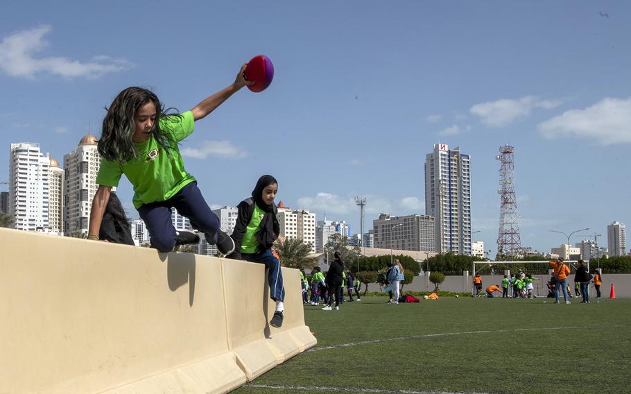 Defense Department elementary school students complete an obstacle course during the annual Sports Day event in Bahrain, Feb. 11, 2020.