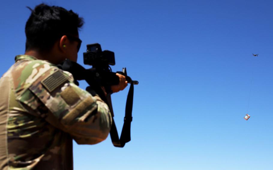 A soldier fires at a box carried by a drone during a Smart Shooter sighting device training event near al-Tanf garrison, Syria, May 30, 2020.