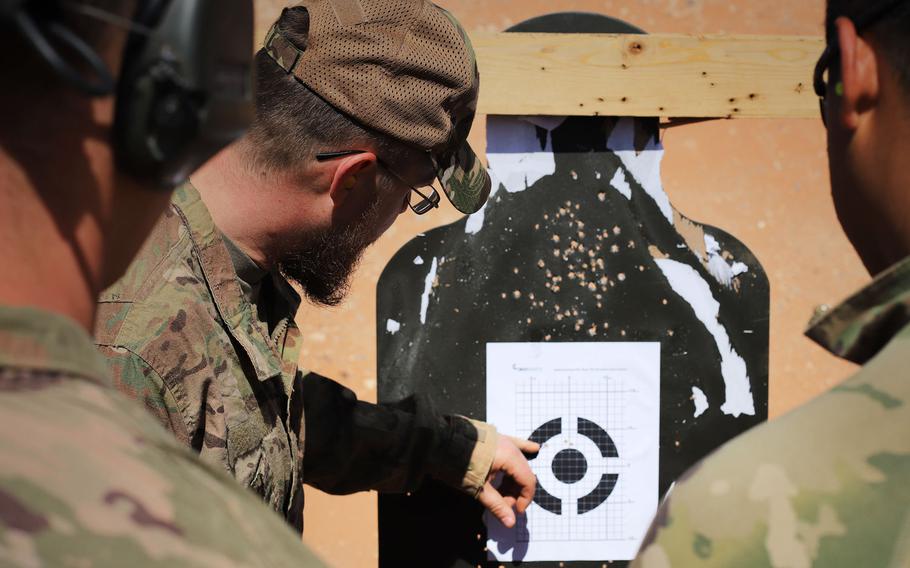 Coalition forces analyze a zero target during a Smart Shooter sighting device familiarization training event near al-Tanf garrison, Syria, May 30, 2020.