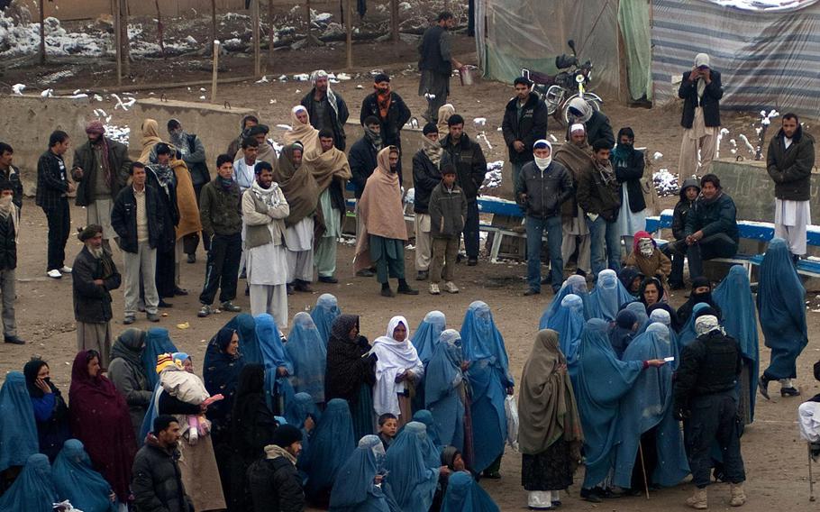 Afghans wait in line to be seen at the South Korean hospital at Bagram Airfield, in a photo taken Feb. 28, 2011. The hospital, largely unused since 2016, was heavily damaged in a Taliban attack on Dec. 11, 2019, and now is being razed, NATO Resolute Support officials said this week.