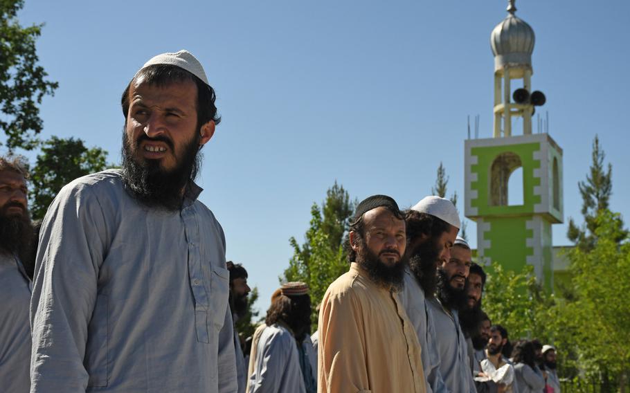 Recently freed Taliban prisoners wait to be transported from Bagram prison on May 26, 2020. Afghanistan will complete a release of 5,000 prisoners shortly in a bid to advance the peace process, President Ashraf Ghani said Thursday.