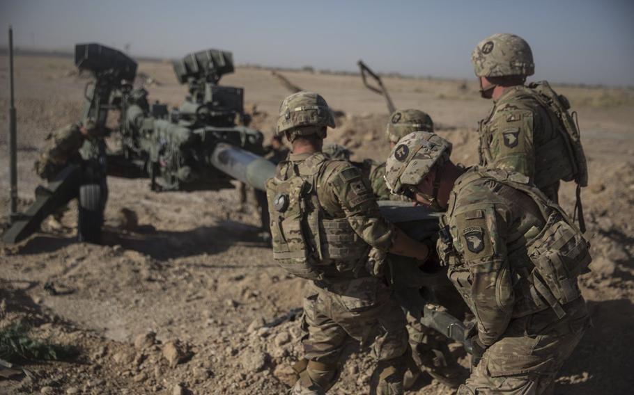 U.S. soldiers with Task Force Iron maneuver an M-777 howitzer so it can be towed into position at Bost Airfield, Afghanistan, June 10, 2017. President Donald Trump viewed a troop increase in Afghanistan early in his term as a failure, former National Security Adviser John Bolton said in a book released to the public Tuesday.