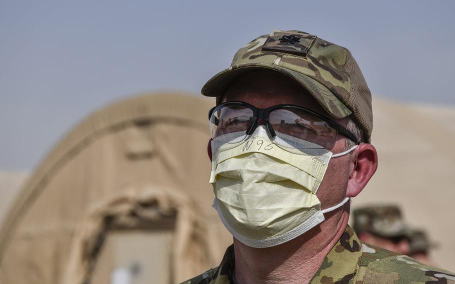 An airman assigned to the 386th Air Expeditionary Wing discusses proposed mitigations during a coronavirus quarantine exercise at Ahmed al-Jaber Air Base, Kuwait, March 13, 2020. A ''cluster'' of COVID-19 cases has developed at the base, officials said.