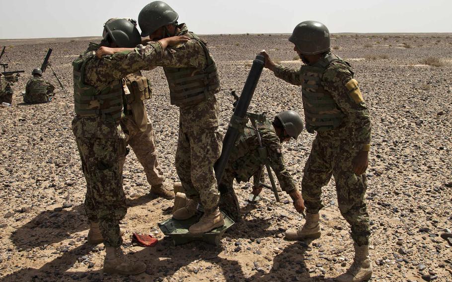 An Afghan National Army soldier prepares to fire an 82mm light mortar outside Camp Dwyer, Helmand province, Afghanistan, in 2012. The United Nations said Tuesday, June 30, 2020, that the Afghan army was responsible for an attack that left dozens, including children, killed or injured in Helmand province on Monday. Soldiers missed their targets while fighting the Taliban and the mortars landed in a cattle market, the U.N. said.