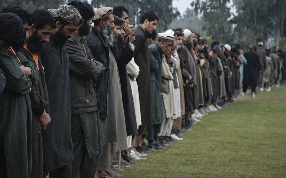 Islamic State fighters line up Nov. 19, 2019, in Jalalabad, Afghanistan, after surrendering to the Afghan government. The group has suffered heavy battlefield losses but remains a threat as it aims to recruit Taliban disgruntled by the peace process.