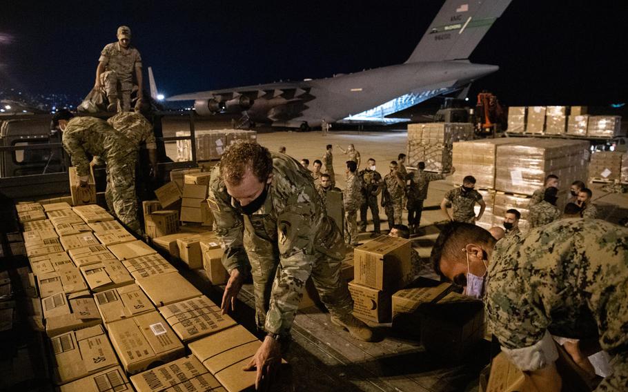 Lebanese and U.S. service members unload humanitarian aid supplies delivered by a U.S. Air Force C-17 Globemaster III at Beirut, Lebanon, Aug. 6, 2020. 