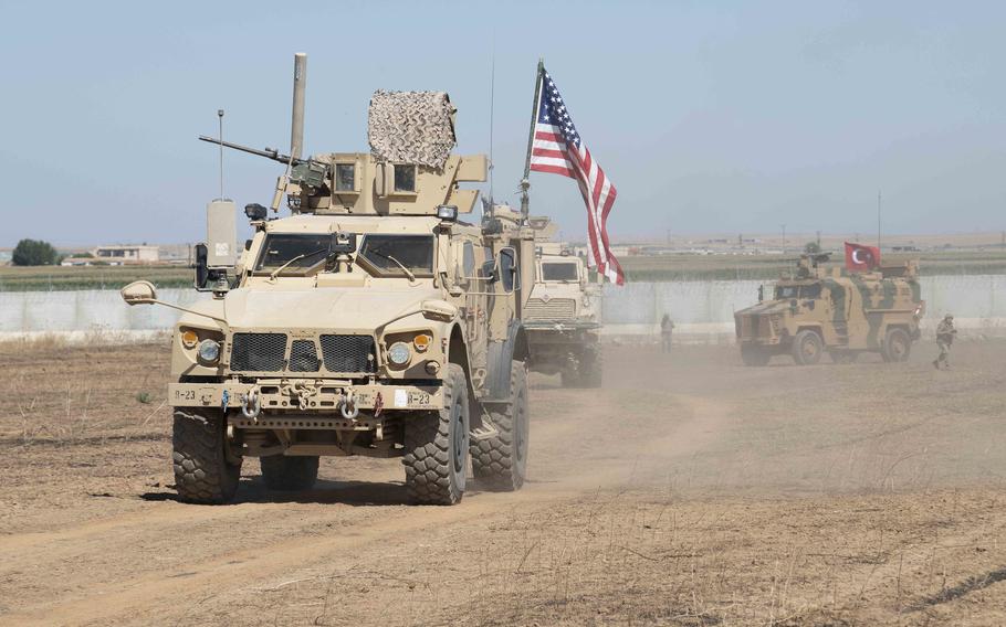 In a September, 2019 photo, U.S. and Turkish military forces conduct a joint ground patrol in northeast Syria. U.S.-led coalition and partner forces returned fire after an attack on their convoy near a Syrian military checkpoint Monday, Aug. 17, 2020, a coalition statement said.
