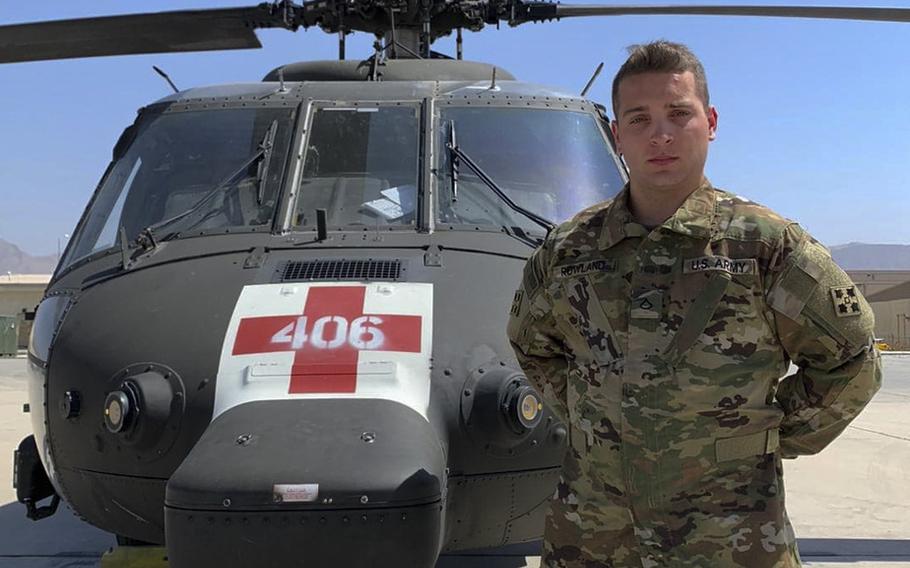 Pfc. Tyler Rowland, 4th Combat Aviation Brigade, 4th Infantry Division, stands next to a UH-60 Blackhawk helicopter, August 13, 2020. Rowland had the chance to meet his stepbrother, who he hadn't seen since he was a baby, while at Bagram Airfield on July 21, 2020.