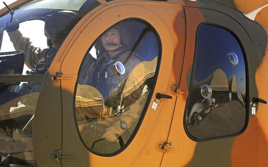 Afghan pilot Maj. Mohammad Naiem Asadi receives final instructions before a solo flight in a MD-530 helicopter, Oct. 16, 2012 at Shindand Air Base, Afghanistan. Asadi and his family had been approved to come to the U.S. for their protection until the Pentagon reversed its endorsement of their exit.