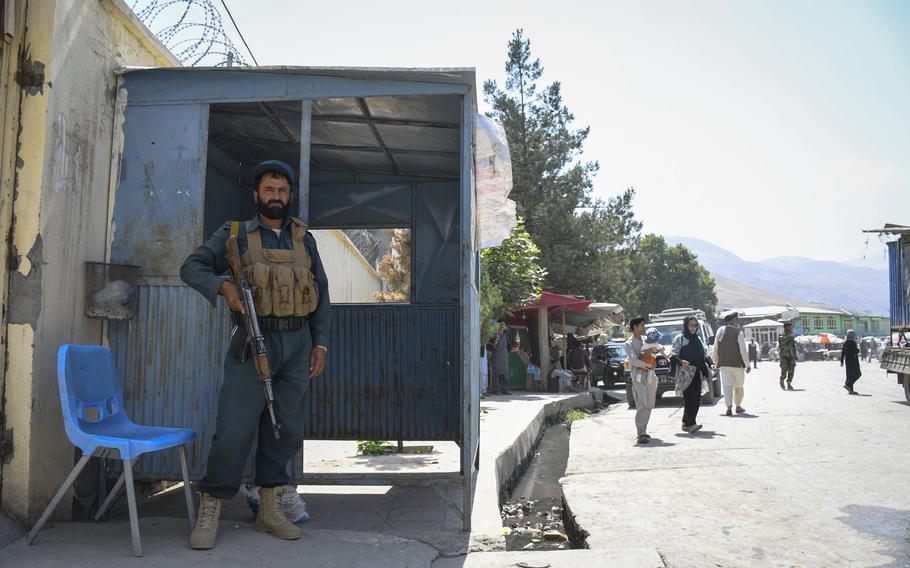 An Afghan policeman guards the entrance of a government building in Faizabad, the provincial capital of Badakhshan province, which was once safe but is now under Taliban threat.